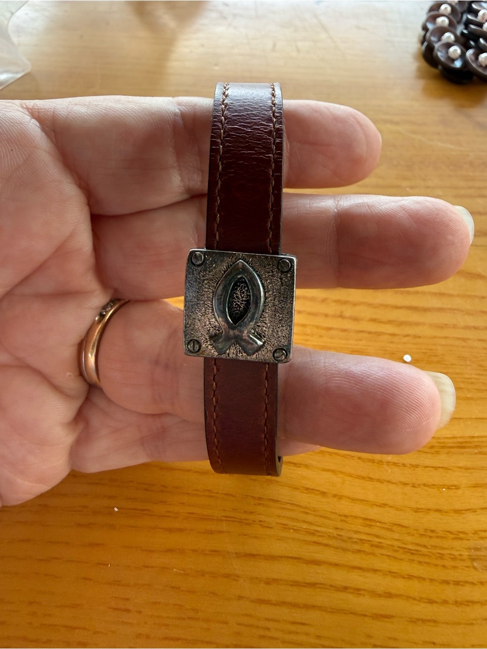 Leather Bracelet emblazoned with a Christian Ichthys fish symbol.